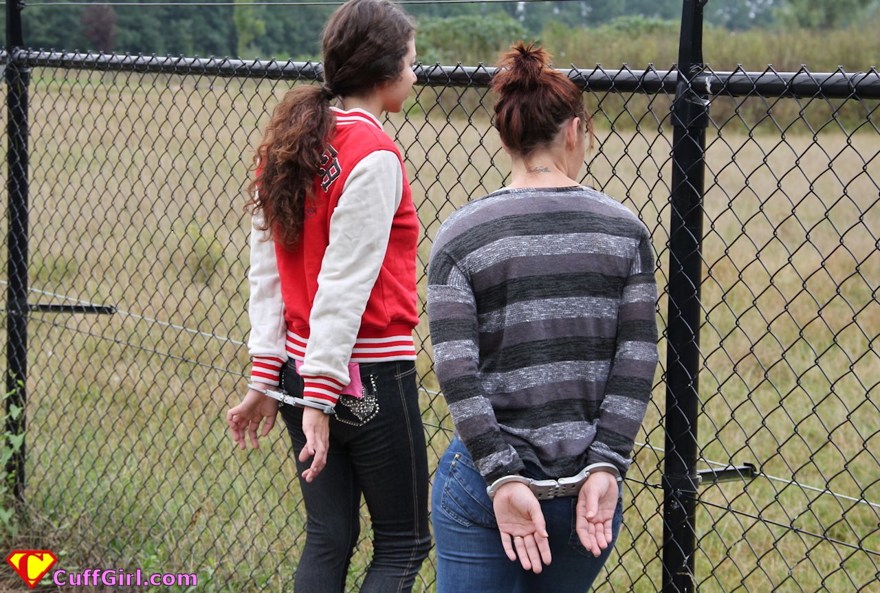 Outdoors in LIPS handcuffs.